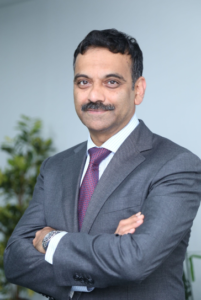 Photo of Zensar Technologies CEO Ajay S. Bhutari in a suit and tie